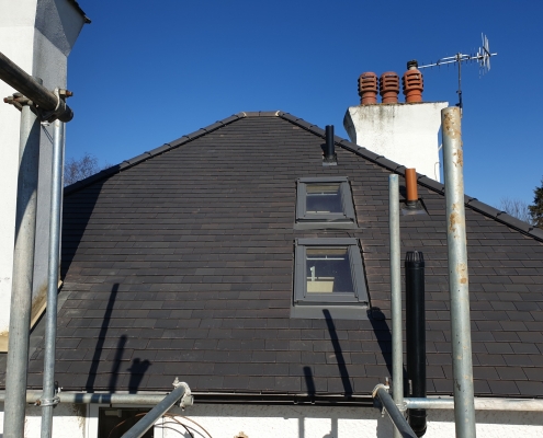 Scaffold Around the Tiled Roof with Velux Windows